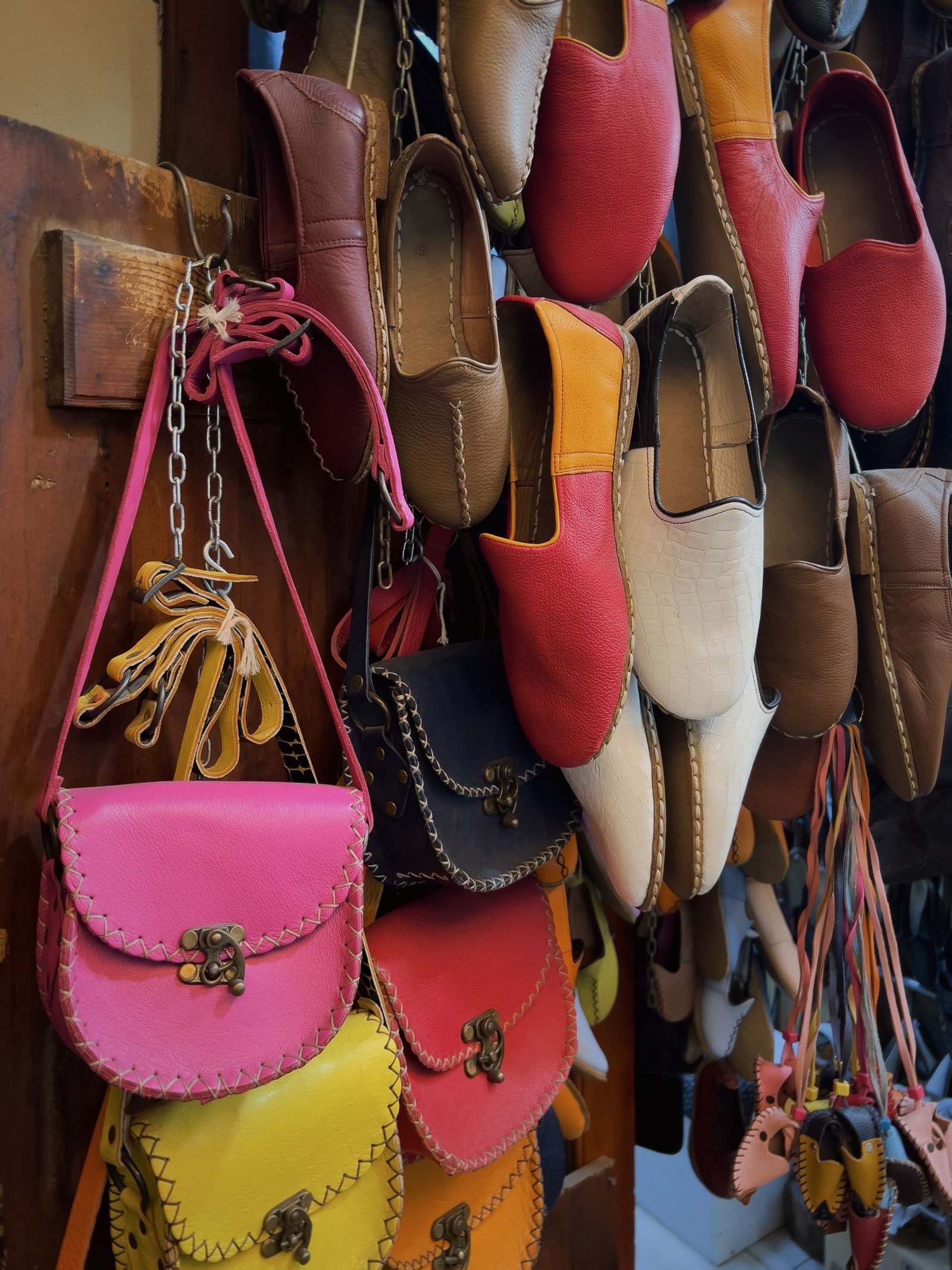 Vibrant display of handcrafted leather shoes and bags in various colors and designs.